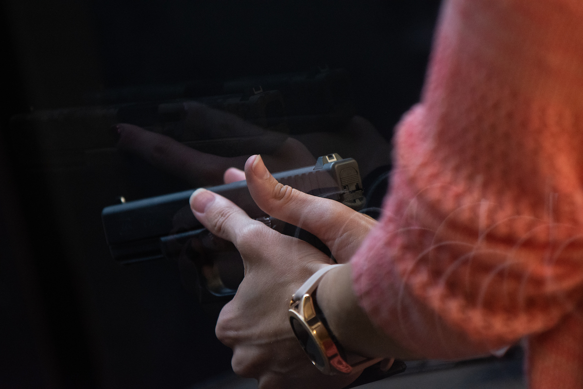 Woman holding a gun in a concealed-carry instructional course