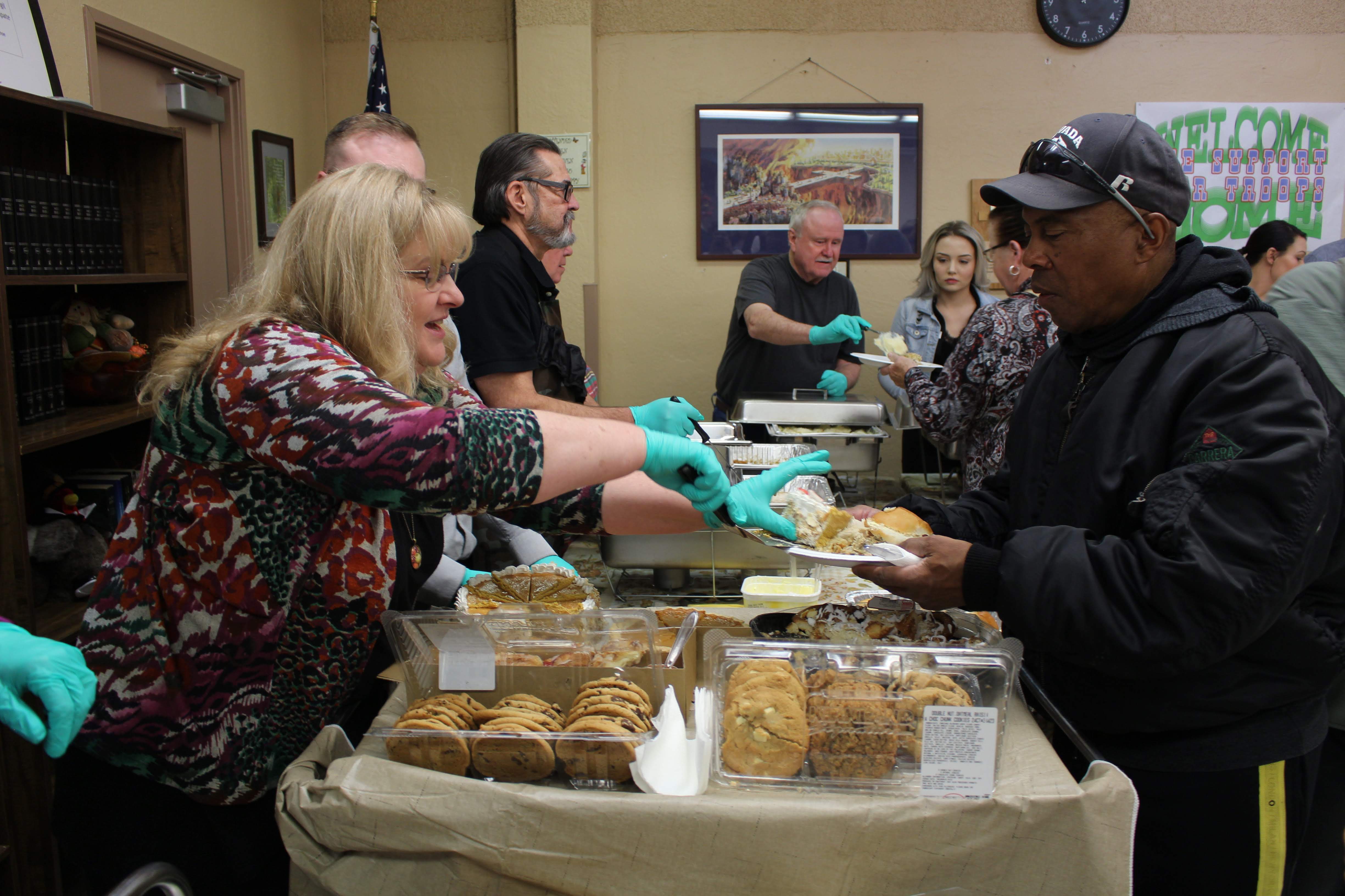 Volunteers serving Thanksgiving meal to veterans