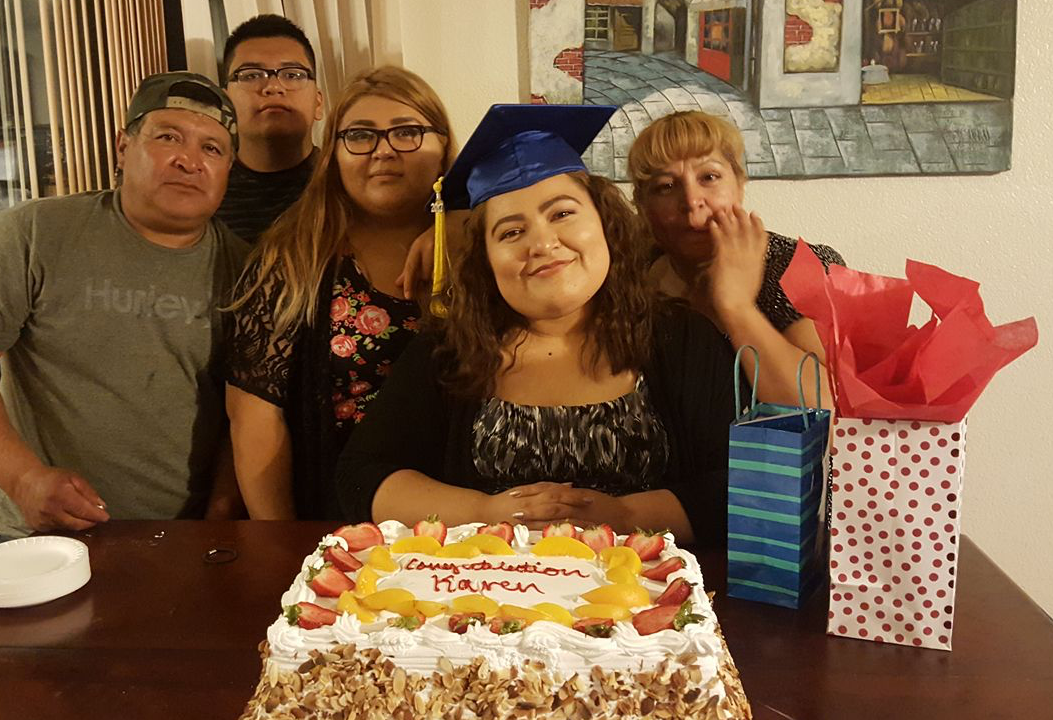 Martinez family with congratulations cake