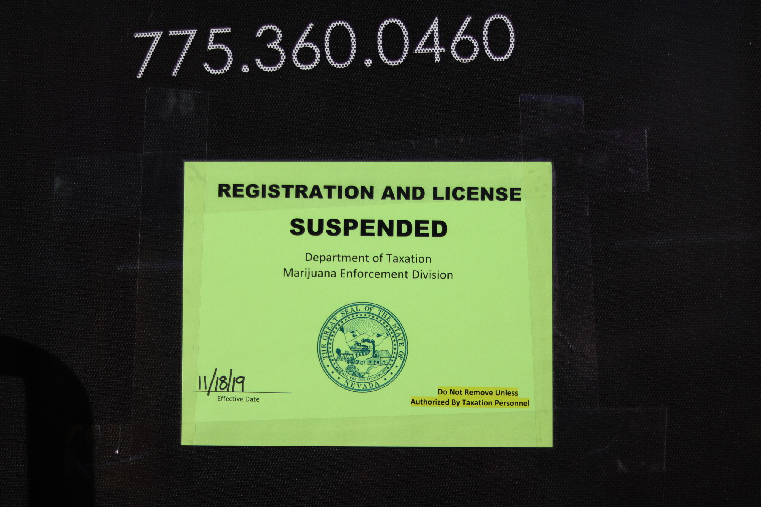A sign saying registration and license suspended