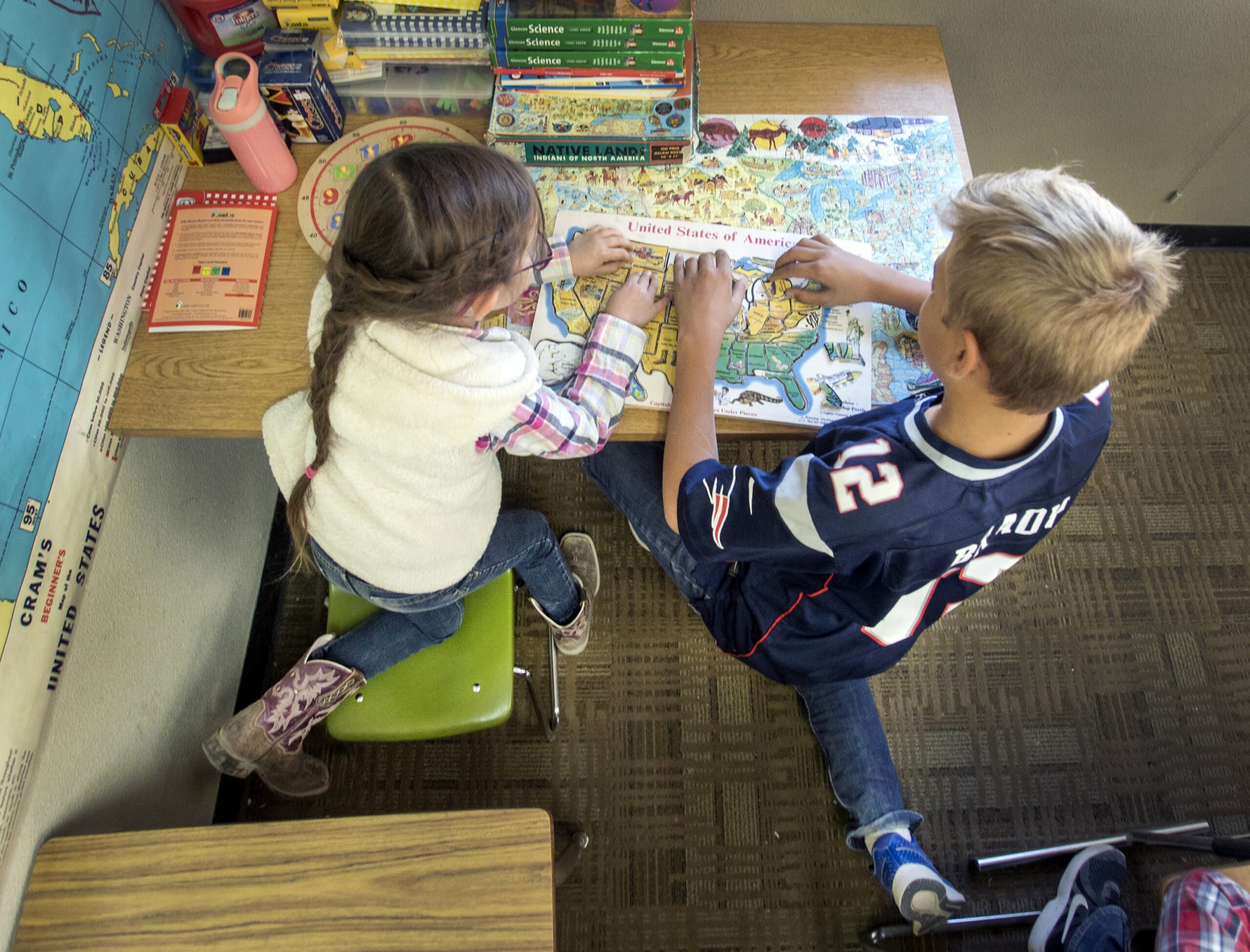 A seventh-grader helps a first-grader at Warm Springs School