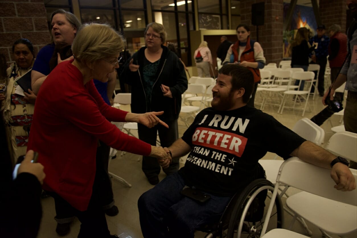 Elizabeth Warren greets a man at her town hall rally