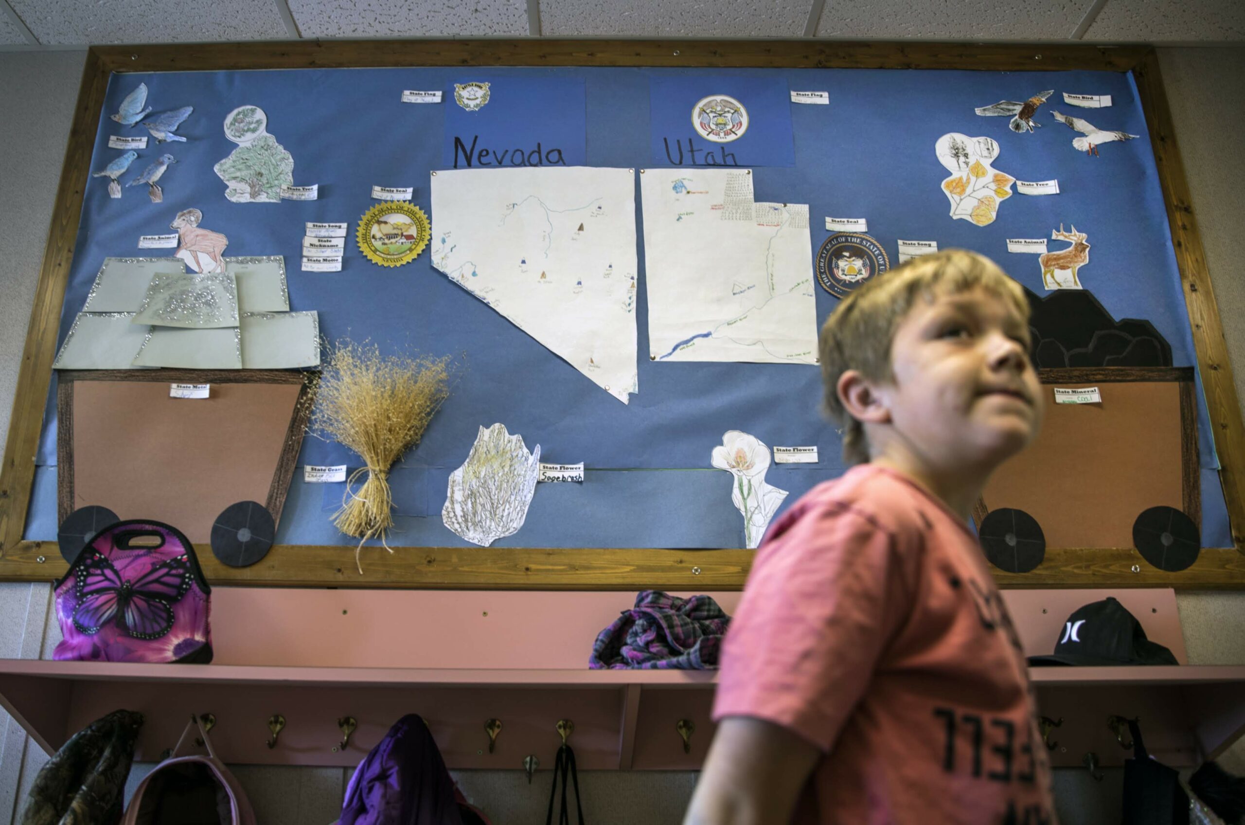 A student wanders past a bulletin board