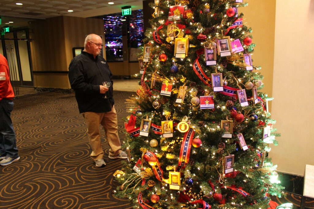 Man looks at Christmas tree