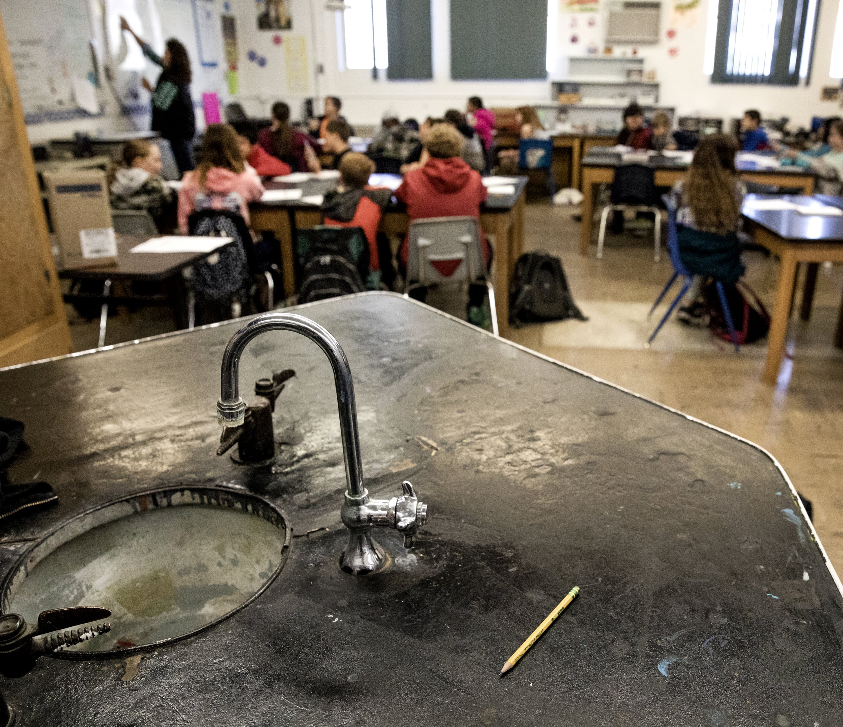 An age-battered laboratory station sits unused inside a science classroom in White Pine Middle School