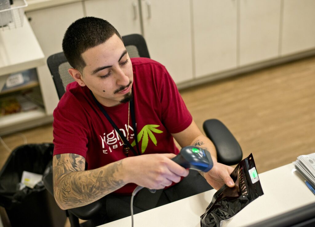 Clerk scanning marijuana barcode