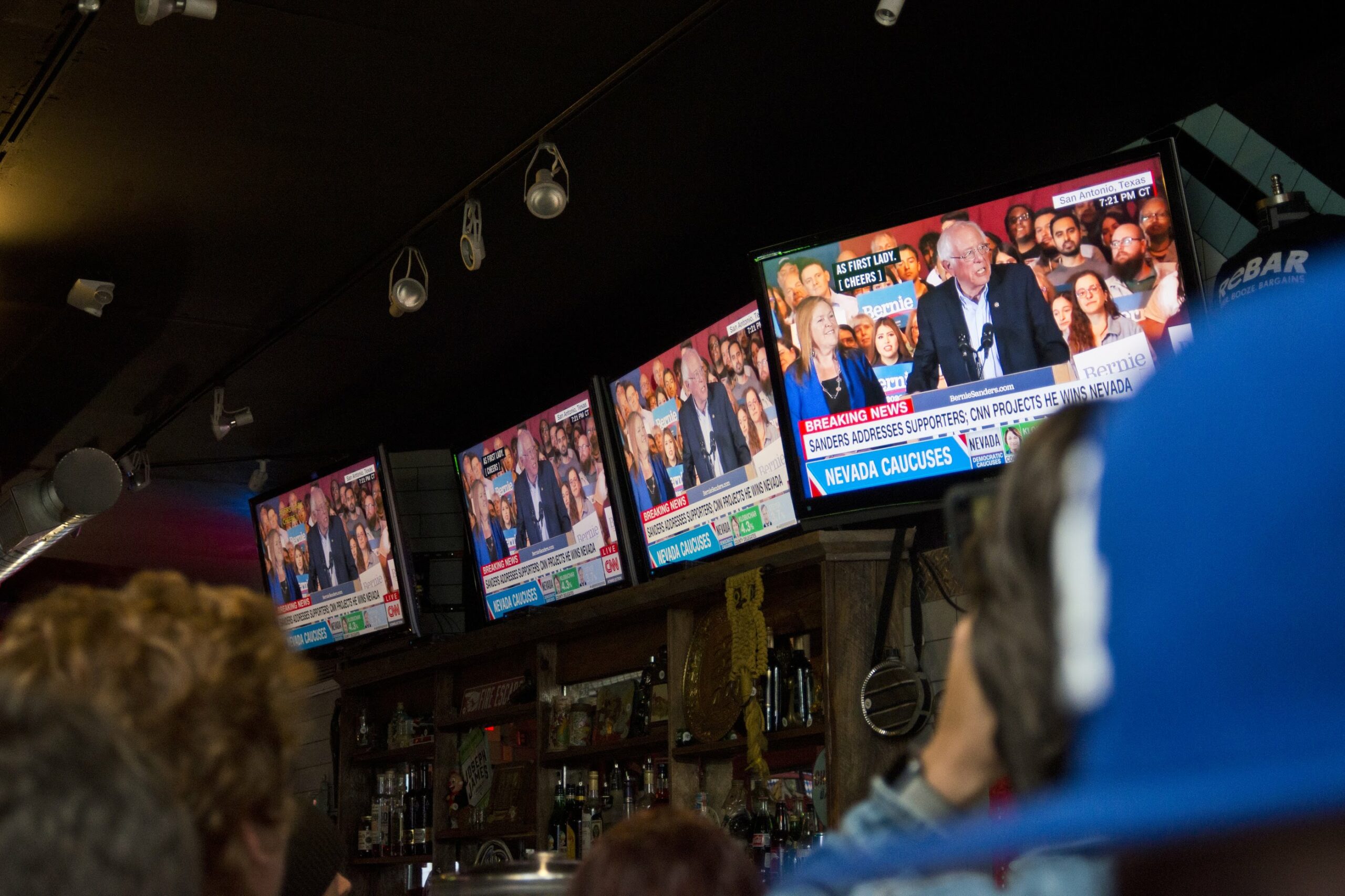 Bernie Sanders on television screens at ReBar in Las Vegas