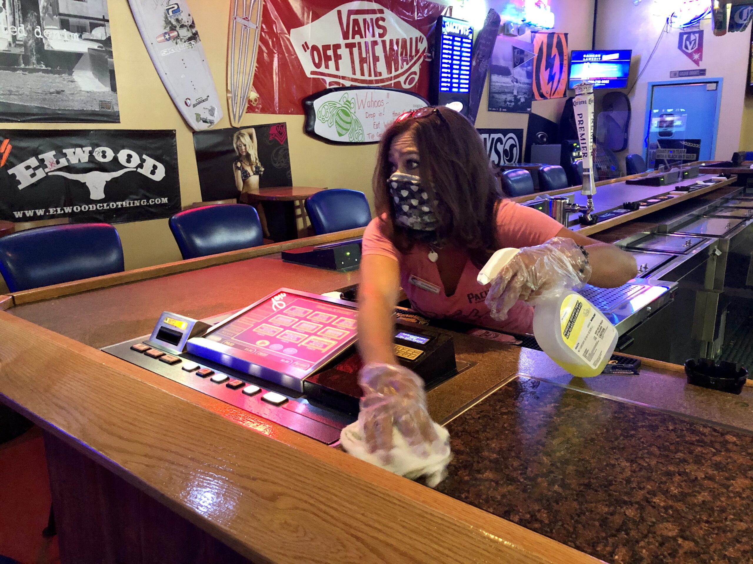 Wahoo’s Fish Tacos bartender Shannon Dunmire cleans one of the Sunset Road and Rainbow Boulevard tavern’s 15 slot machines after a customer ended a gaming session