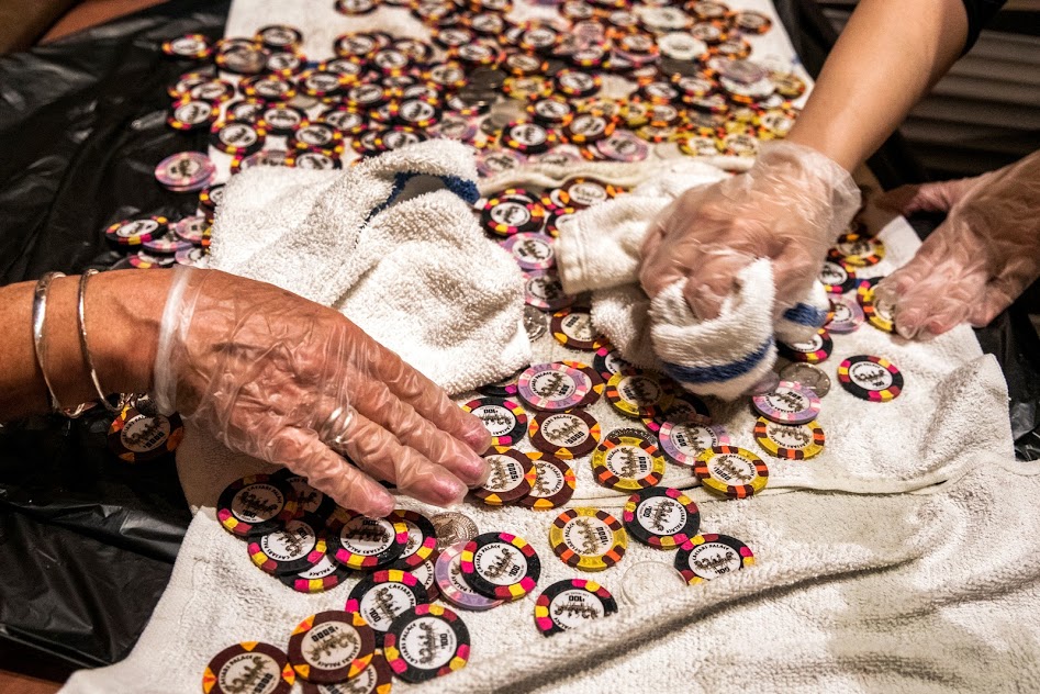 Employees at Caesars Palace disinfect casino chips at the property