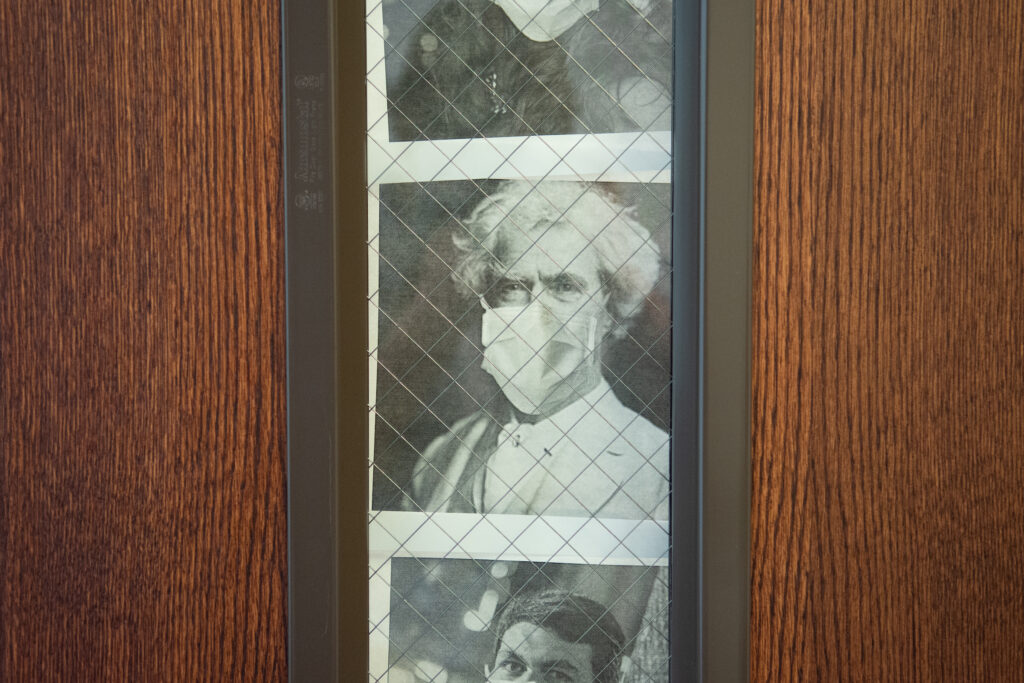 A photo illustration of Mark Twain wearing a mask decorates the Senate GOP office door