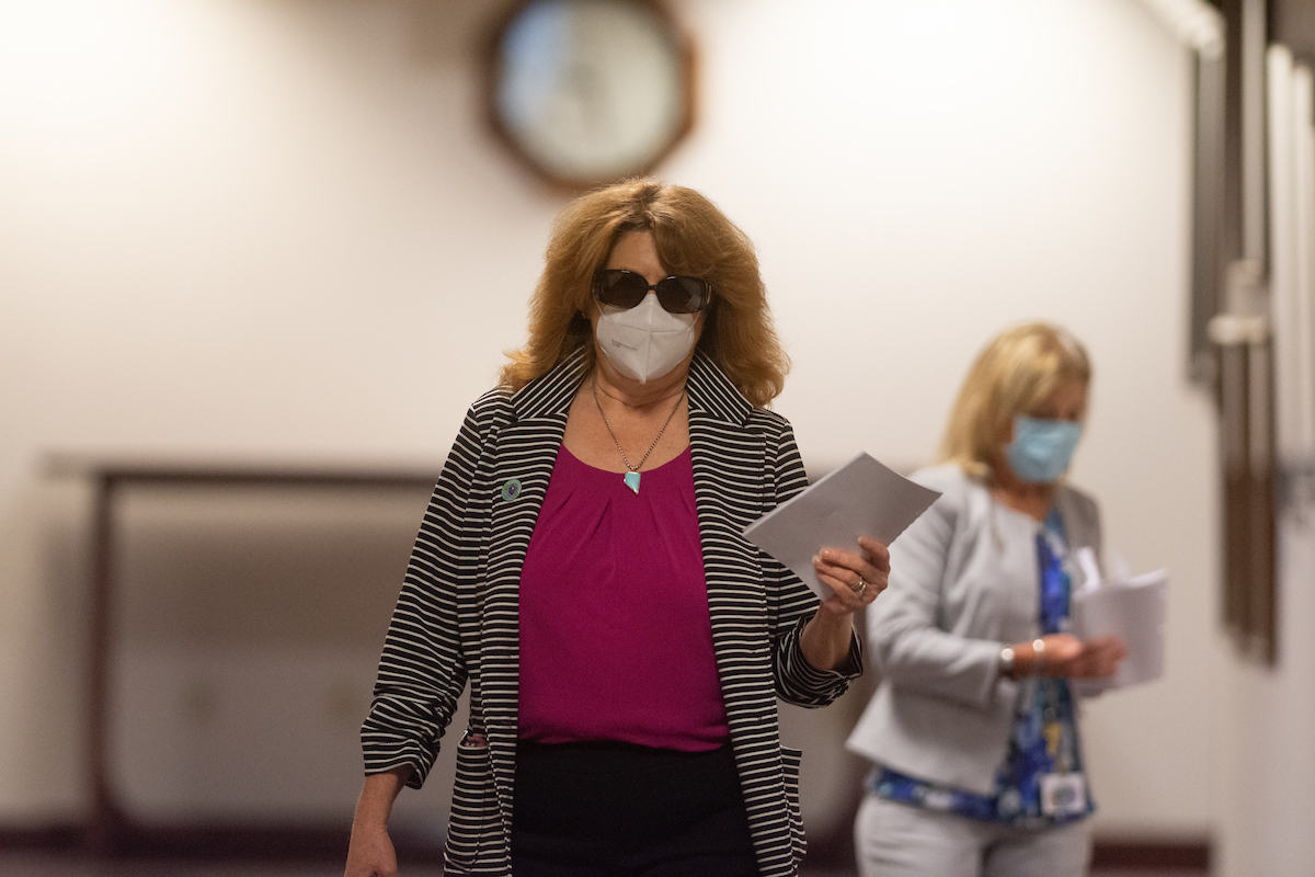 Assemblywoman Ellen Spiegel walking in a hallway with papers in her hand