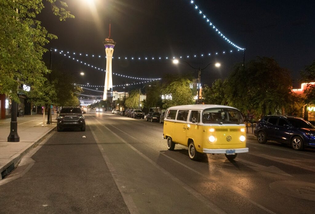 A vehicle travels on Main Street in the Arts District at night.