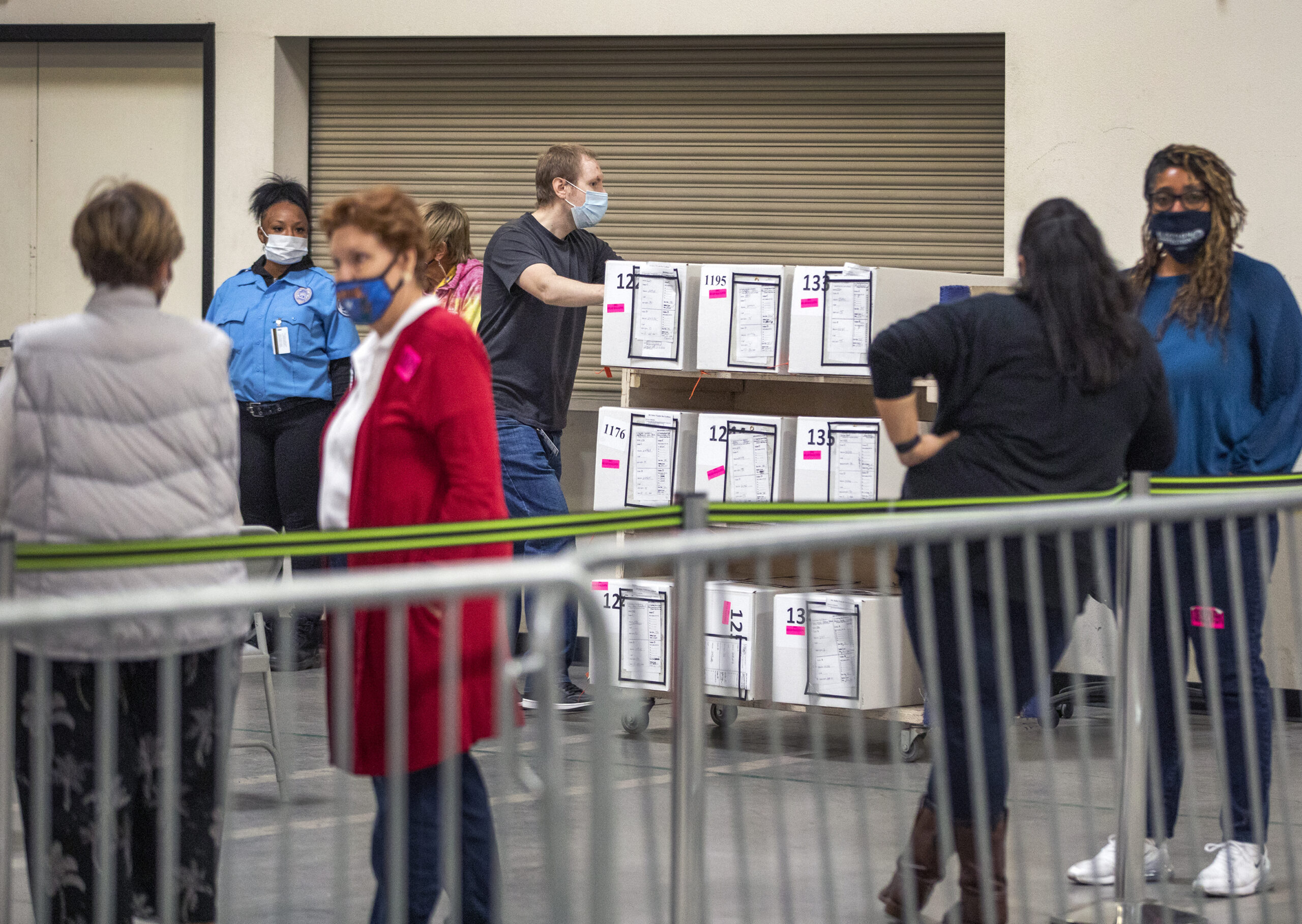 A man pushes a cart full of ballots past observers in the Clark County Election Department on Thursday, Nov. 5, 2020. (Jeff Scheid/The Nevada Independent).