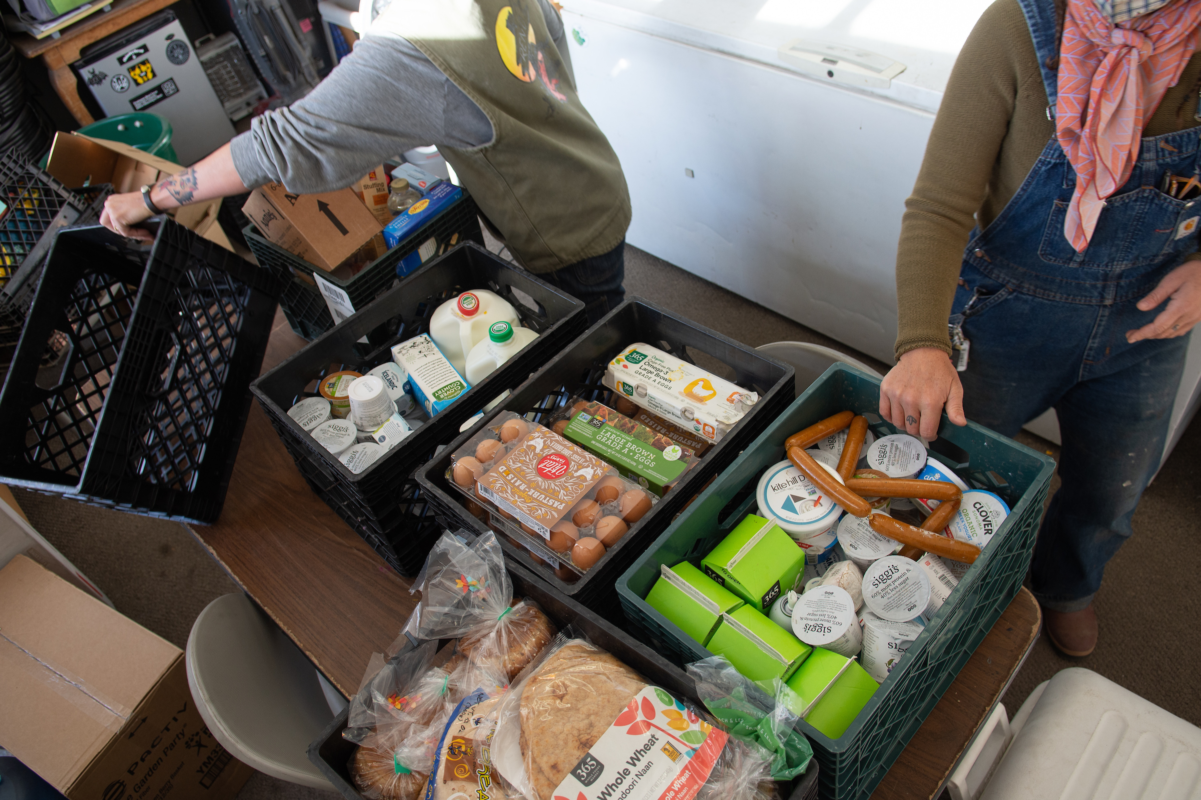 Lyndsey Langsdale and Meagan O'Farrell sort donated food at the Reno Food Systems office.