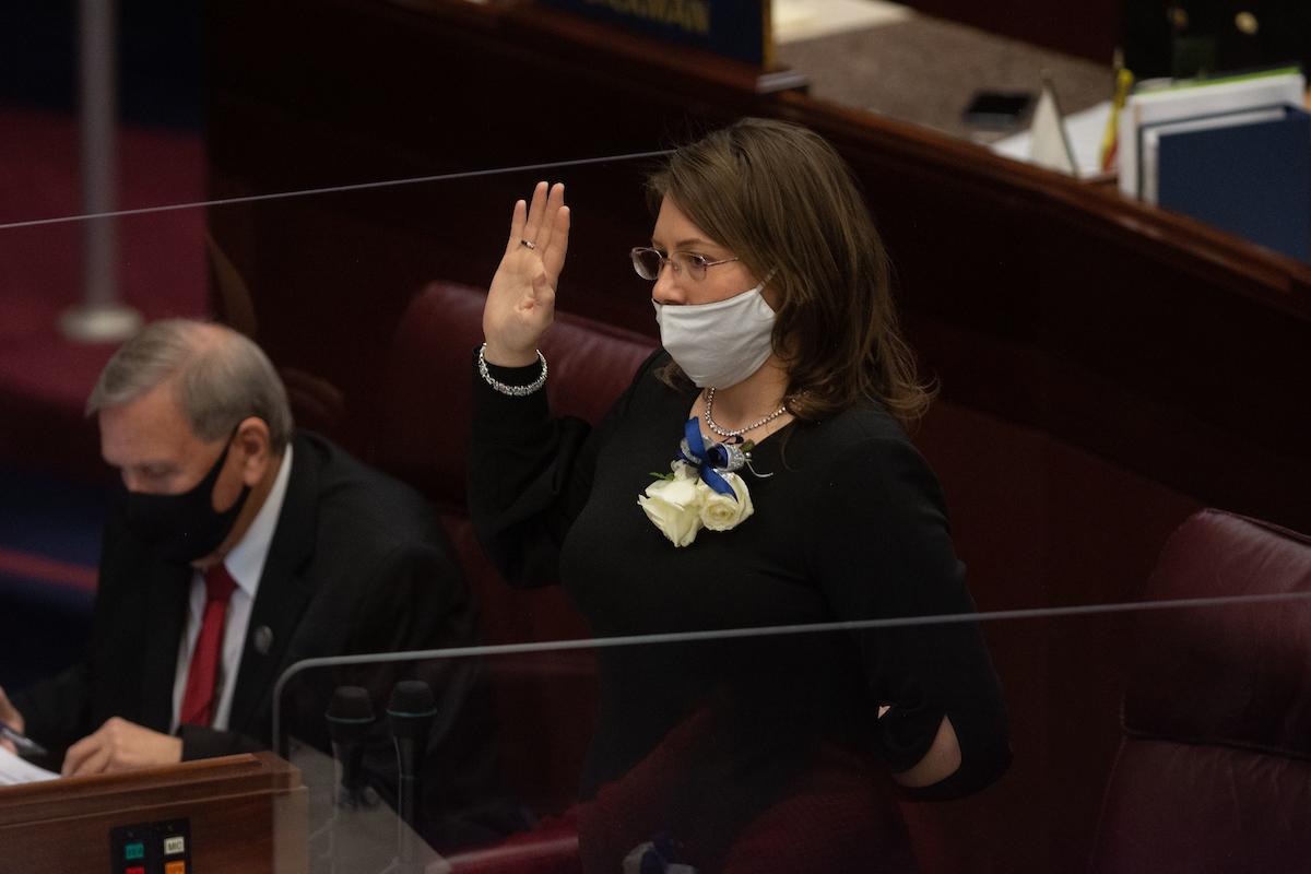 Assemblywoman Annie Black standing with her right hand raised