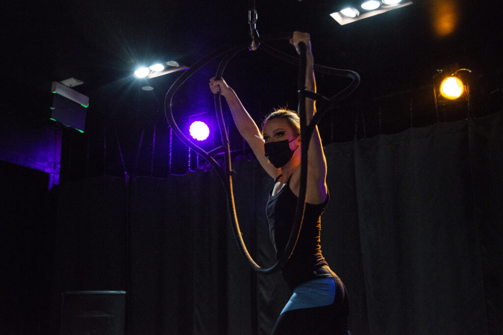 Aerial hoops artist Angelique Janowski hangs from a hoop