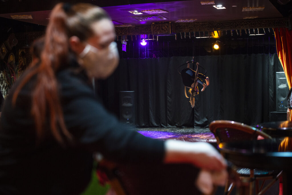 Aerial hoops artist Angelique Janowski warms up on stage.