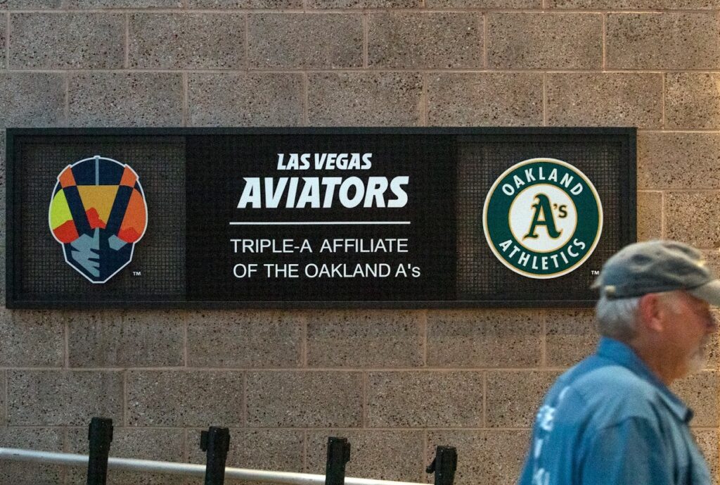 A man walks past a sign at the Las Vegas Ballpark on Thursday, July 14, 2021. (Jeff Scheid/The Nevada Independent)