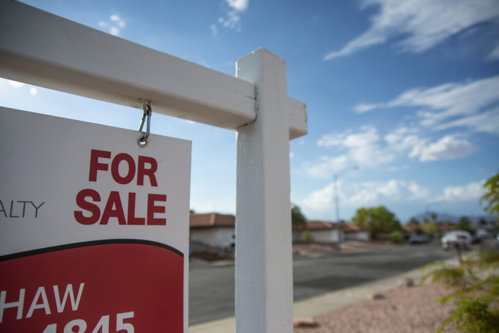 for sale sign by house