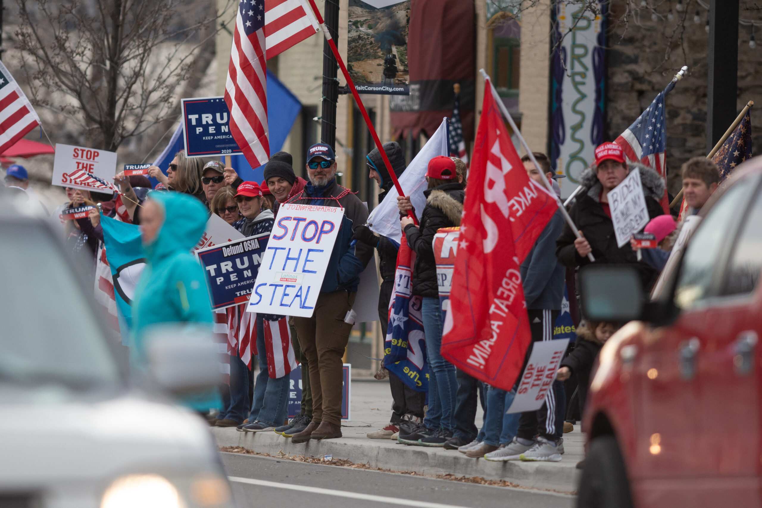 Protesters wave signs at a "Stop the Steal" rally in Carson City on Monday, Jan. 6, 2020. (David Calvert/The Nevada Independent)