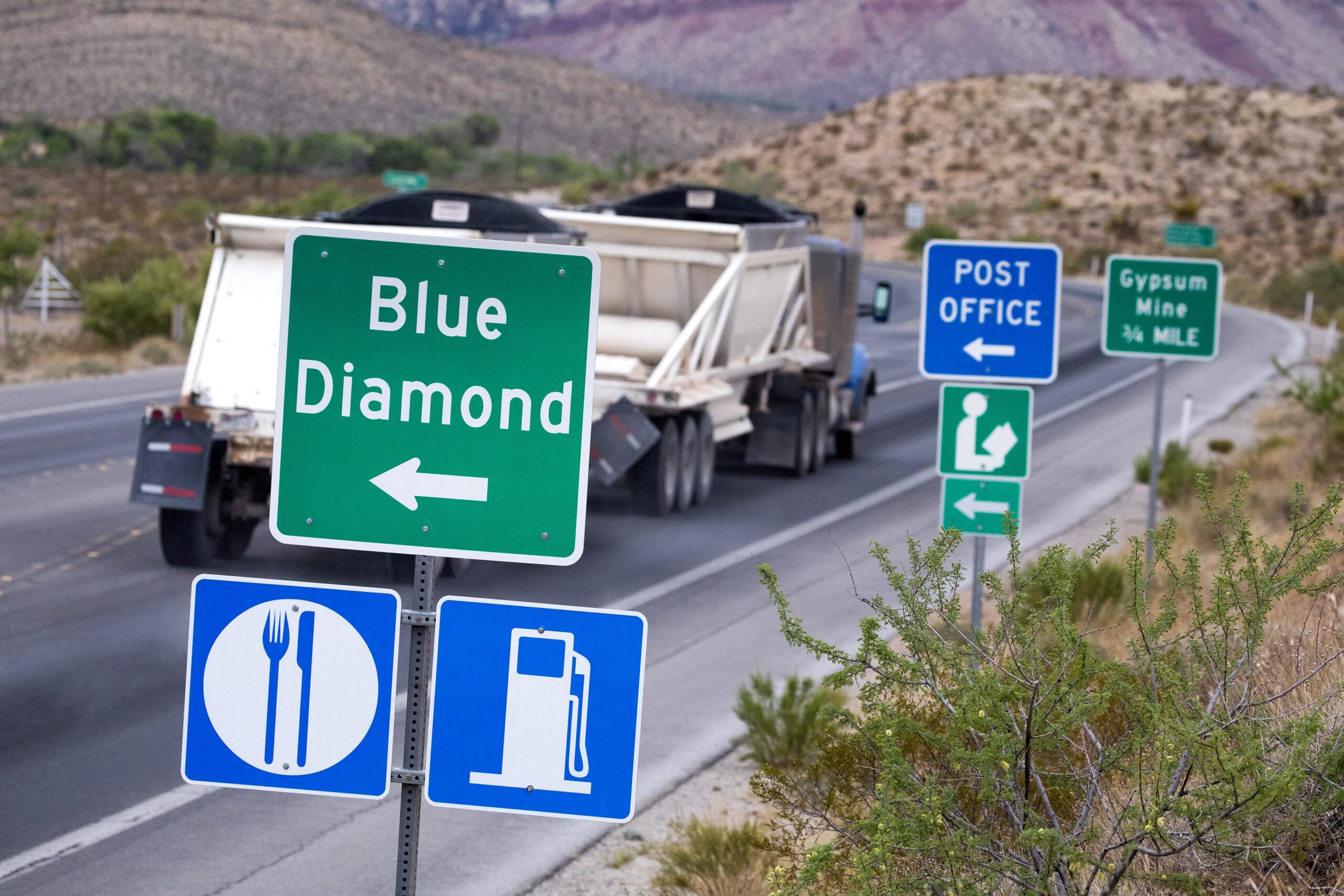 A semi-truck travels on State Route 159 near the Red Rock Canyon National Conservation Area on Monday, June 7, 2021.