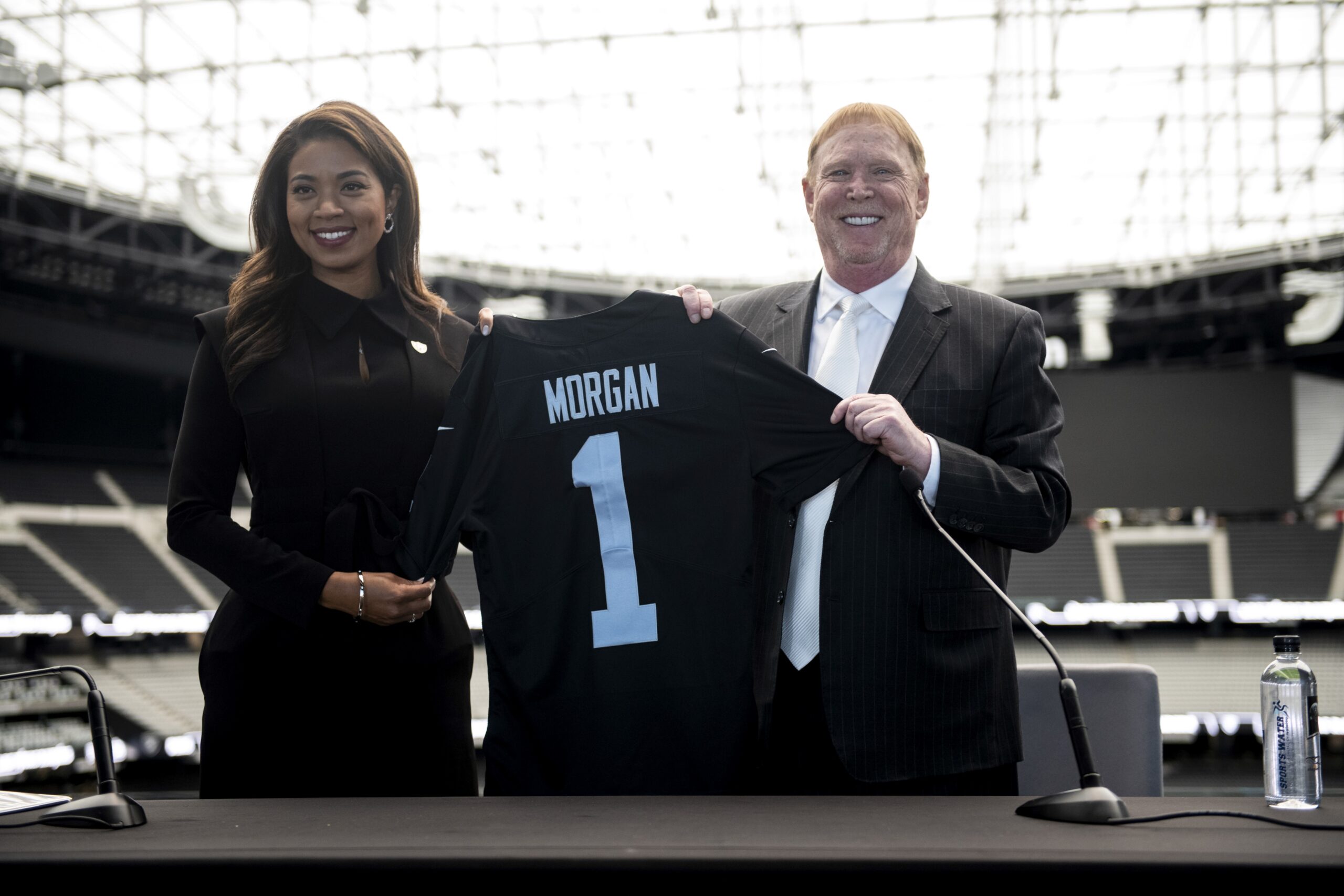 Las Vegas Raiders owner Mark Davis, center, speaks during a news  conference, officially renaming the Oakland Raiders to the Las Vegas Raiders,  in front of Allegiant Stadium in Las Vegas Wednesday, Jan.