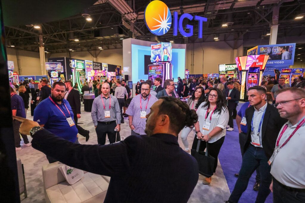 Attendees watch a demonstration of a gaming machine at the IGT booth during G2E on Tuesday, Oct. 11, 2022. (Jeff Scheid/The Nevada Independent)