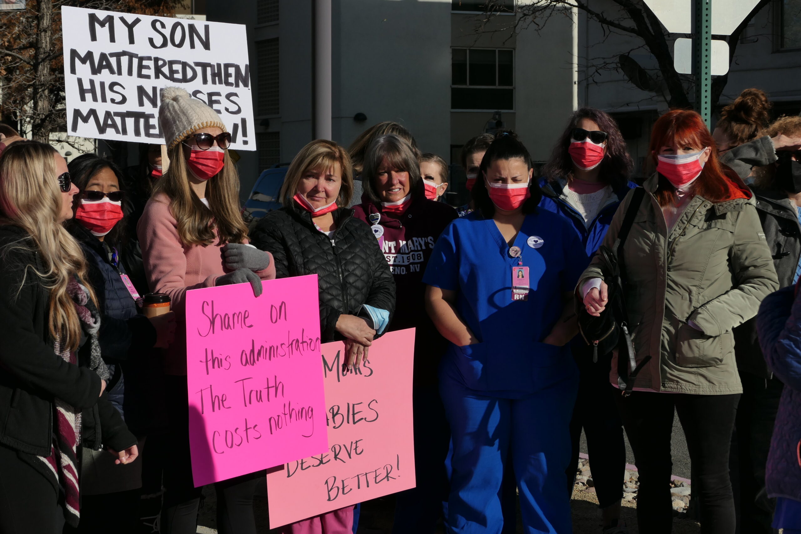 Nurses and supporters stand outside St. Mary's to mourn the discontinuation of maternity services