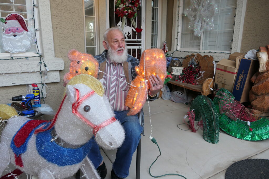 David Roberts sets up his Christmas display the evening of Nov. 30, 2022 