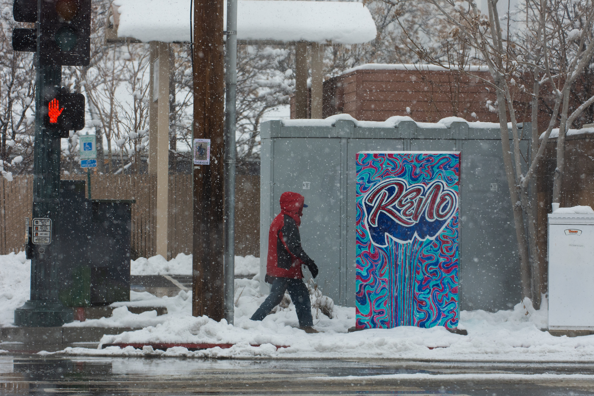 Man walking on snowy sidewalk in Reno
