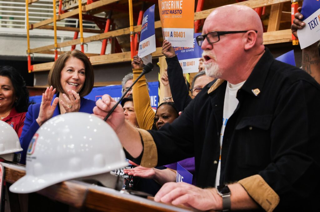 Senator Catherine Cortez Masto claps while Frank Hawk speaks