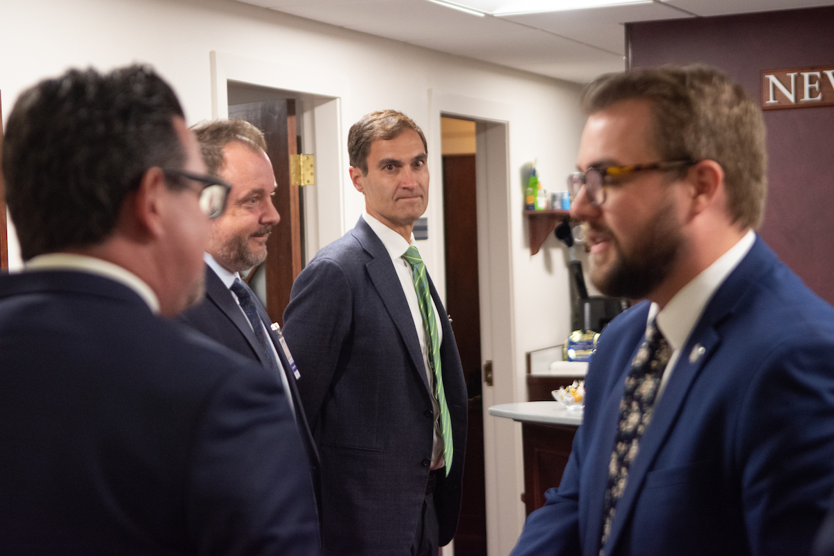 Oakland Athletics President Dave Kaval, center, inside the Nevada Legislature for a meeting in Assembly Speaker Steve Yeager's office on Wednesday, April 26, 2023, in Carson City. (David Calvert/The Nevada Independent)