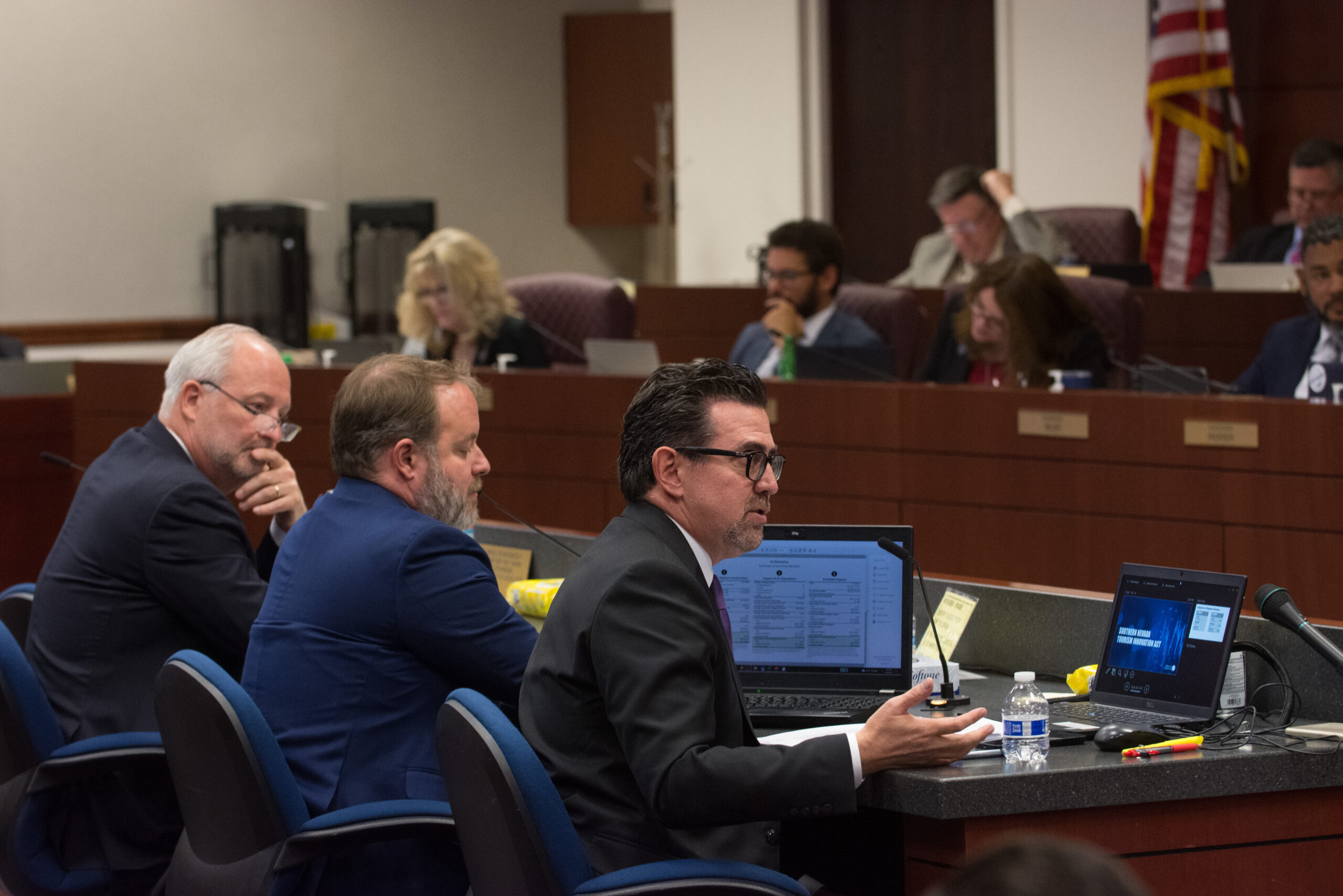 From left, Las Vegas Convention and Visitors Authority CEO Steve Hill, State Treasurer Zach Conine and Applied Analysis founder Jeremy Aguero testify on SB509 on Monday, May 29, 2023 in Carson City. (David Calvert/The Nevada Independent).