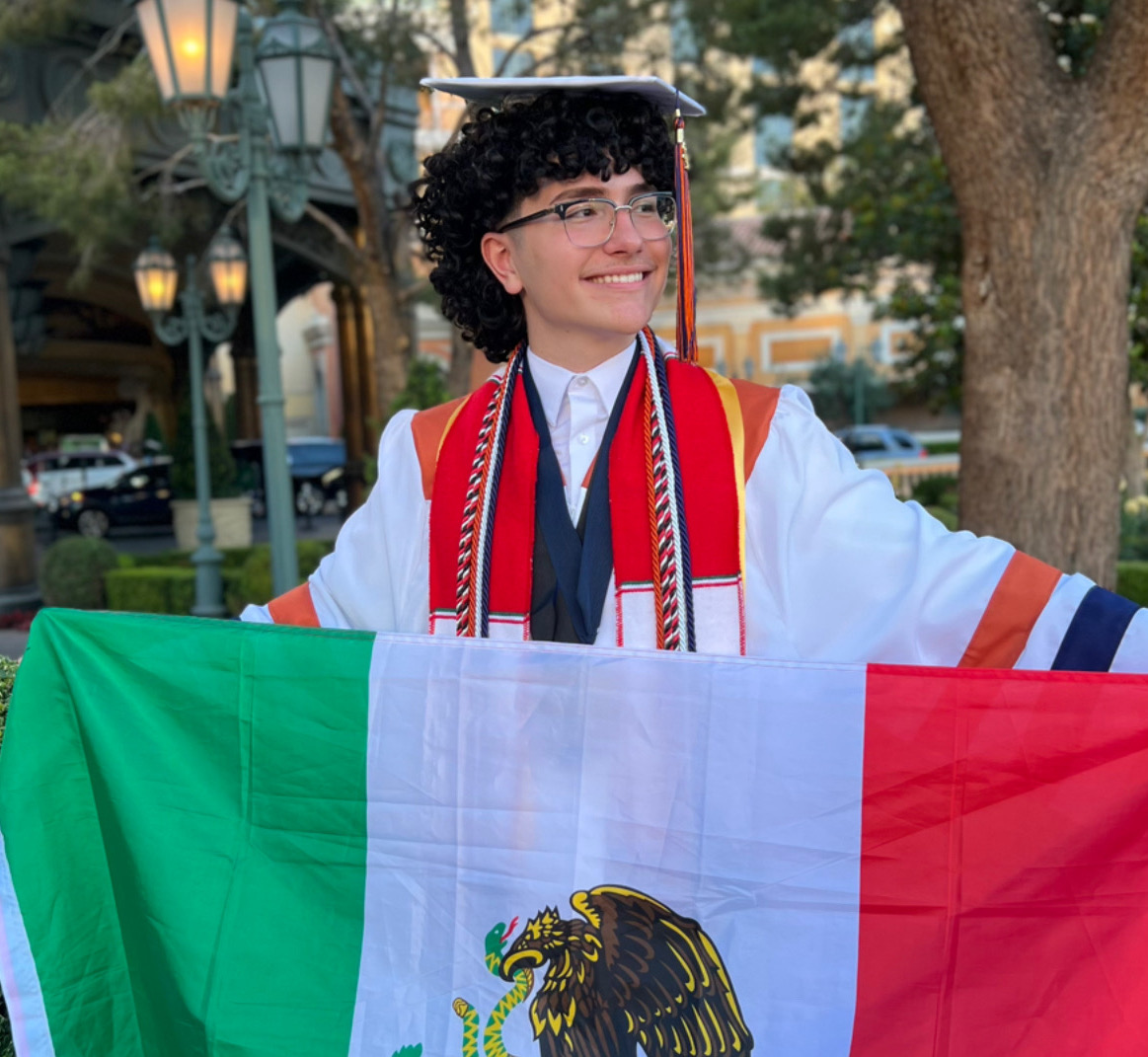 Pablo Macias Lopez in his cap and gown holding a Mexico flag the day of his graduation. (Courtesy of Pablo Macias Lopez) .