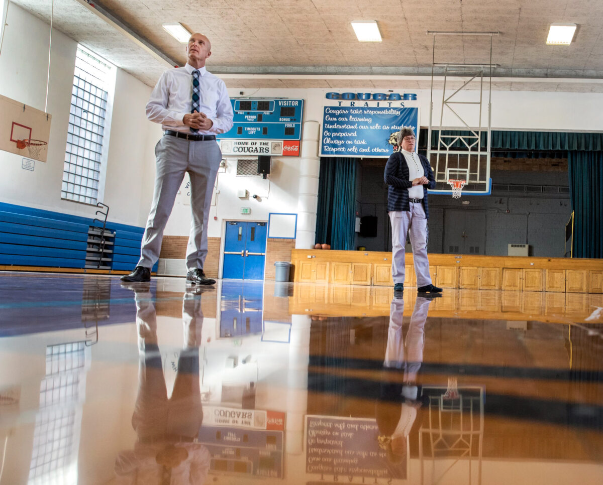 White Pine County School District Superintendent Adam Young, left, and Principal Susan Jensen talk about the condition of the gymnasium floor inside White Pine Middle School.