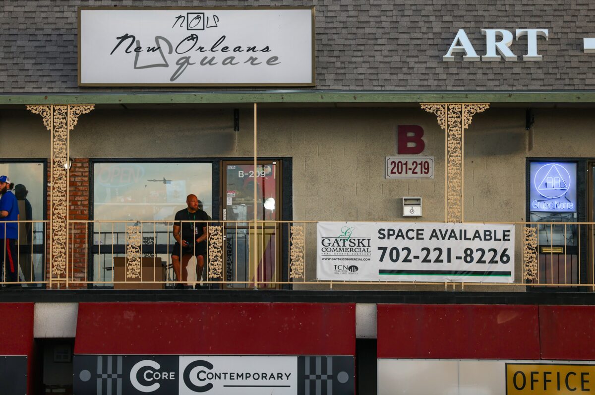 A man sits on the second floor at New Orleans Square during The Fabulous Commercial Center Block Party on Thursday, May 18, 2023. (Jeff Scheid/The Nevada Independent)