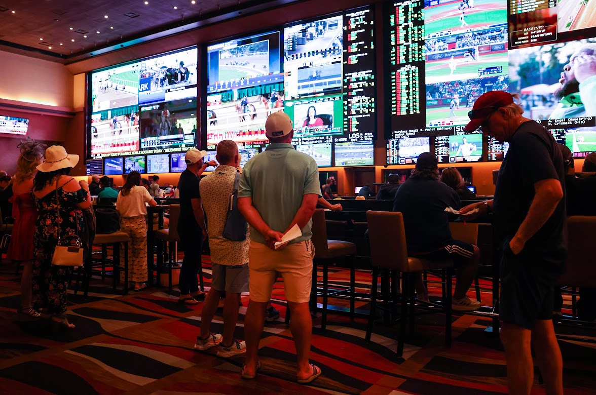 Guests watch sports on the large television monitors and check betting odds at Red Rock Resort sportsbook on Saturday, May 6, 2023. (Jeff Scheid/The Nevada Independent).