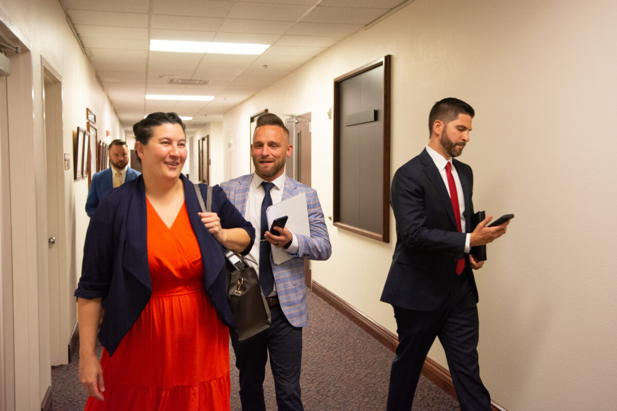 Sen. Rochelle Nguyen, left, walks with Scott Leedom, center, director of public affairs for Southwest Gas Corporation inside the Legislature in Carson City on May 30, 2023. (David Calvert/The Nevada Independent)