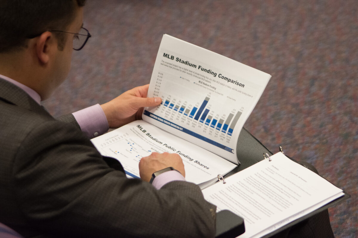 A staffer browses a presentation by the Oakland A's for a $1.5 billion stadium in Las Vegas.