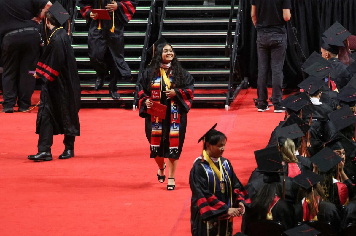 Citlali Bravo Reyes, Southeast Career and Technical Academy class of 2023 graduate, walks back to her seat after receiving her diploma on Thursday, May 25, 2023. (Jeff Scheid/The Nevada Independent).