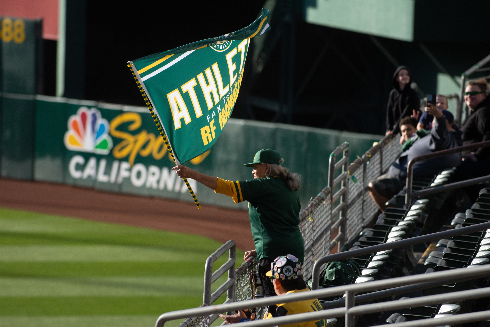 The Oakland Athletics play the Texas Rangers at the Oakland Coliseum in Oakland, California on Friday, May 12, 2023. (David Calvert/The Nevada Independent). A fan is waving a flag in the stands.