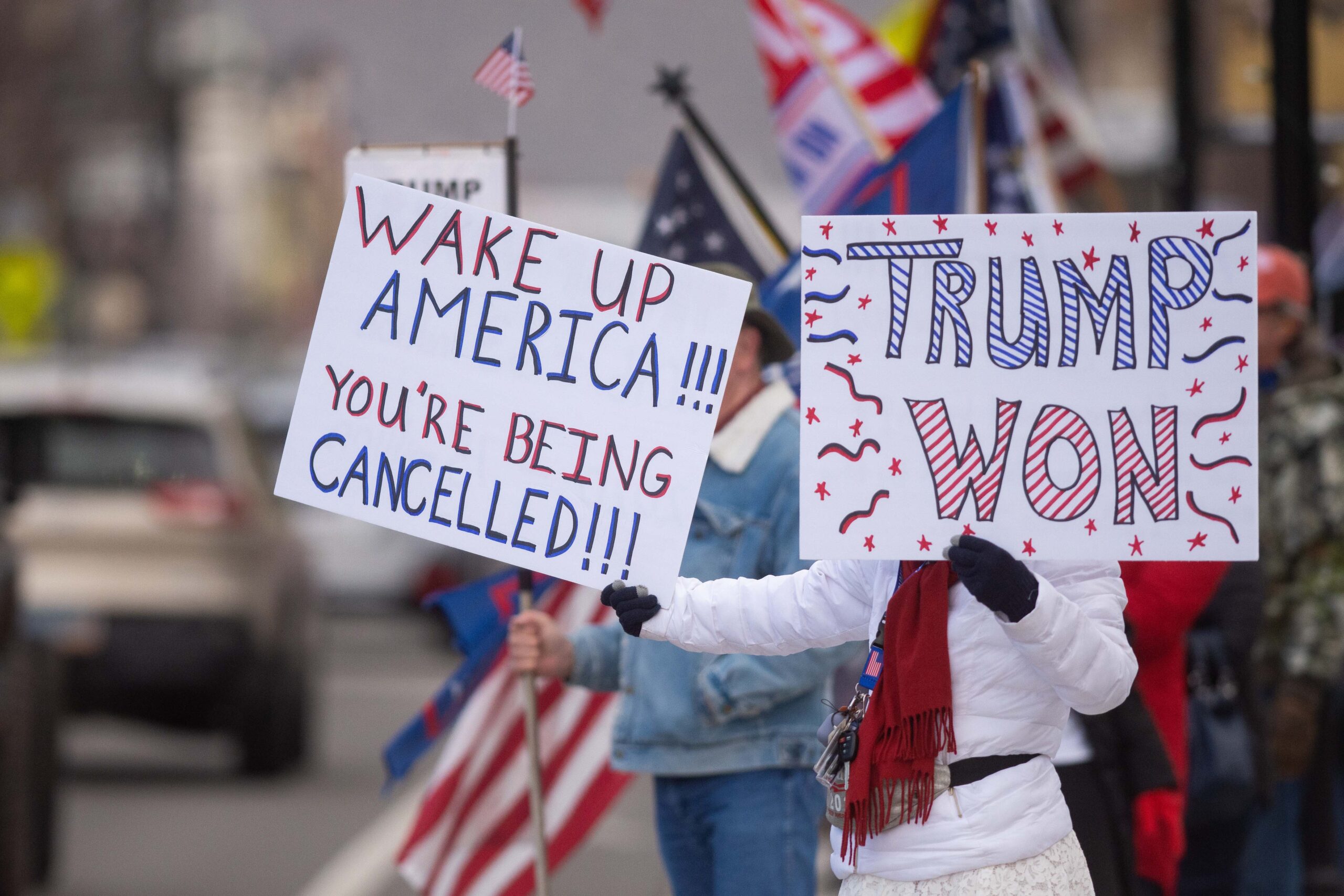 Protesters wave signs at a "Stop the Steal" rally in Carson City on Monday, Jan. 6, 2021. (David Calvert/The Nevada Independent).