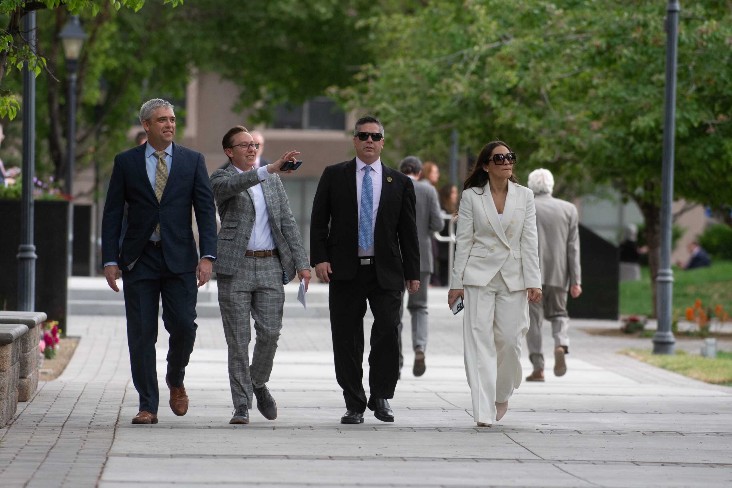 Lobbyists Joshua Hicks, left, and Lindsay Knox walk with Assembly Speaker Steve Yeager, second from right, and Assemblywoman Sandra Jauregui outside the Legislature during the final day of the 82nd legislative session in Carson City on June 5, 2023. (David Calvert/The Nevada Independent).
