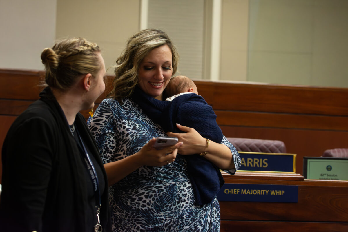 Senate Majority Leader Nicole Cannizzaro (D-Las Vegas) holds her newborn son, Case, inside the Legislature in Carson City on June 4, 2023. (David Calvert/The Nevada Independent).