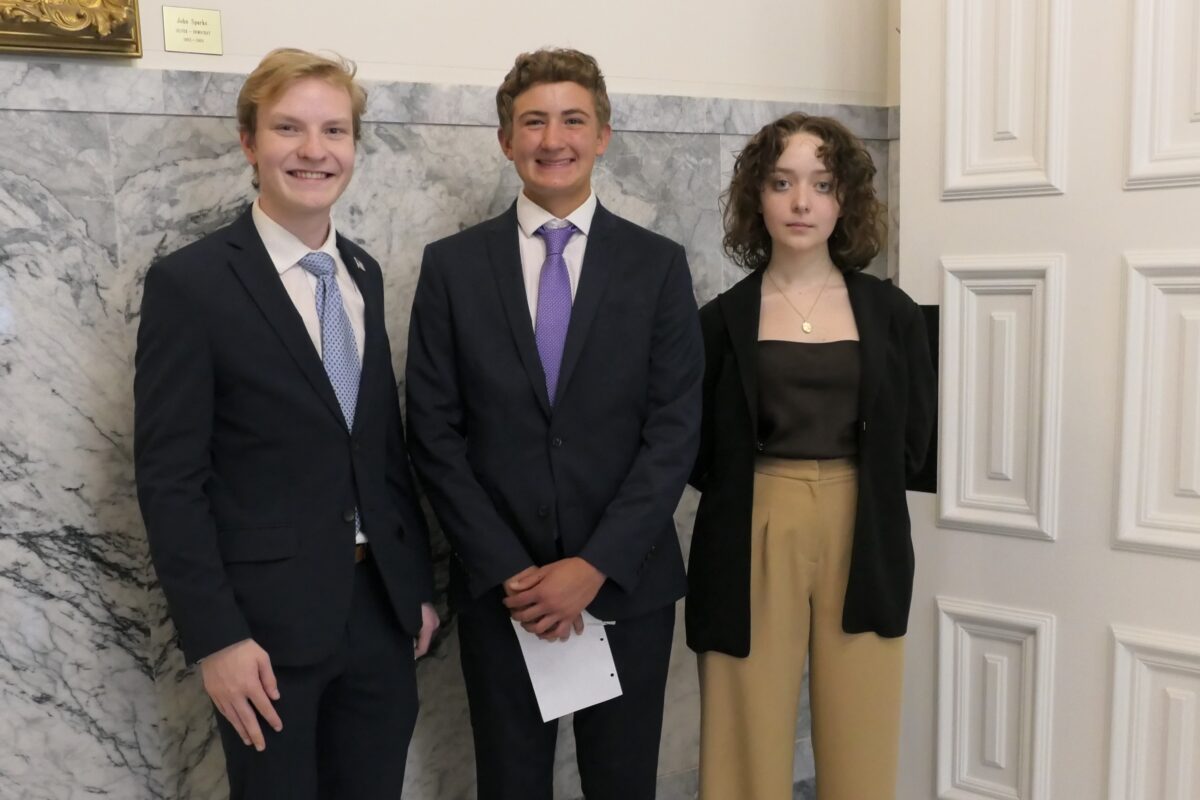 Nevada youth legislators Dillon Moss (left), Joseph Seddon (middle) and Madeline Krieger (right) outside the governor's office in Carson City after SB80's ceremonial bill signing on Thursday, June 15, 2023. (Carly Sauvageau/The Nevada Independent).