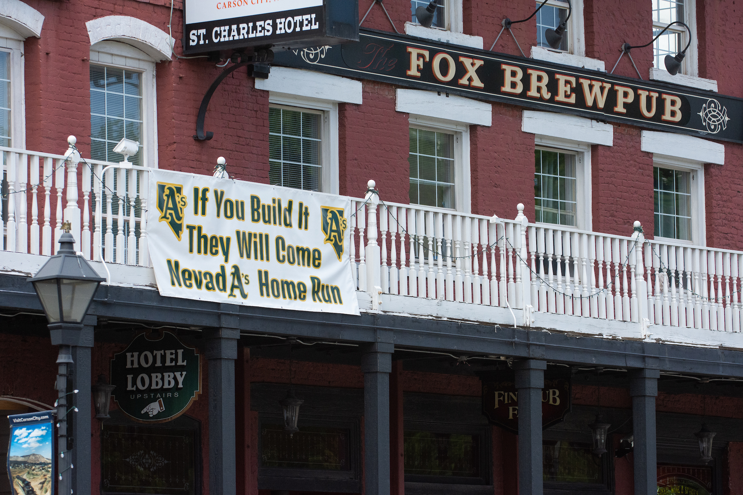 Signage supporting the Oakland Athletics hangs on the St. Charles Hotel across the street from the Legislature in Carson City on June 4, 2023. (David Calvert/The Nevada Independent).