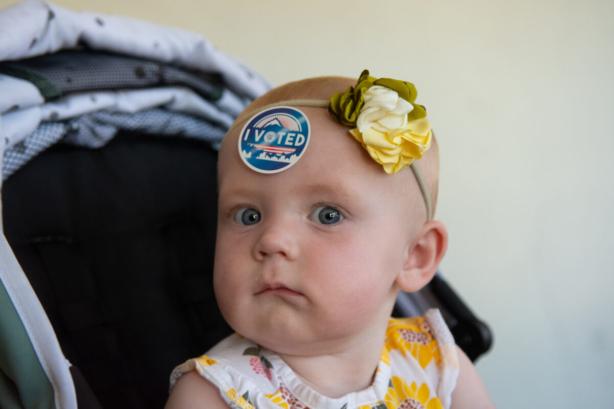 One-year-old Annabelle at the Reno High School voting center with her dad on primary Election Day in Reno on June 14, 2022. (David Calvert/The Nevada Independent)