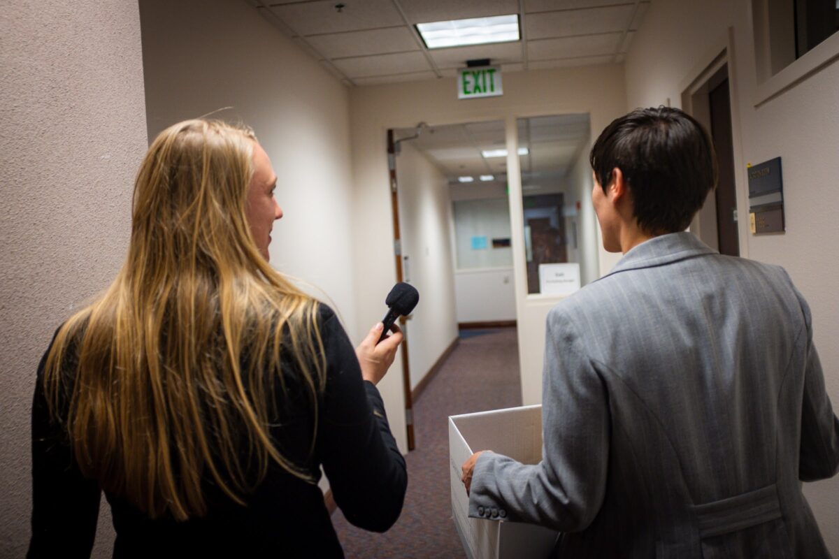 Reporter Alex Couraud (left) interviewing lobbyist Lea Case (right) on the final day of the regular legislative session, June 5, 2023, in Carson City. (Joey Lovato/The Nevada Independent).