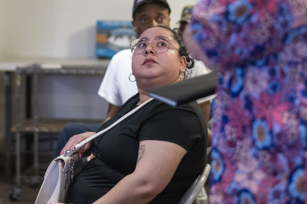 Kennia Valdez, who recently moved into the neighborhood, listens to a speaker during a community meeting at Macedonia Baptist Church in the Windsor Park neighborhood in North Las Vegas on Saturday, May 13, 2023. (Daniel Clark/The Nevada Independent).