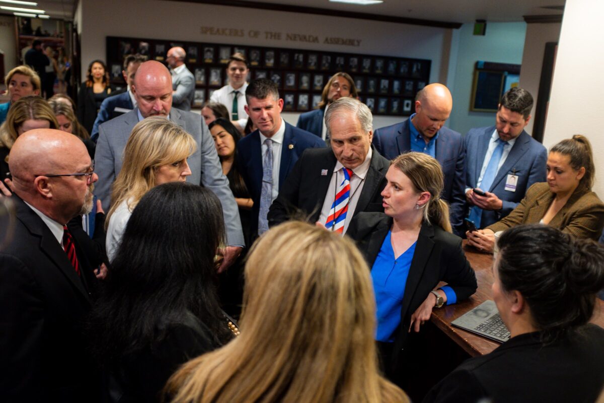 Lawmakers meeting in a hallway during a conference committee surrounded by reporters and lobbyists on the final day of the legislative session, June 5, 2023, in Carson City. (Joey Lovato/The Nevada Independent).